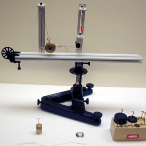 Hang weights on the pendulum on the Pasco rotator until it hangs straight up and down.  Record that weight and then remove.  Now, rotate the apparatus until the pendulum hangs straight down again and record the rotation rate.  The force applied by the rotation rate is the same as the static force applied by the weights.  