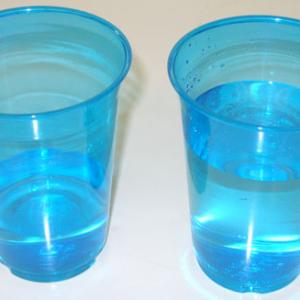 Fill one plastic cup 1/4 full of water.  Fill the other cup 3/4 full with water.