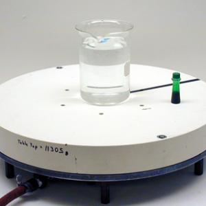 Set a beaker of water in the middle of the rotating air table.