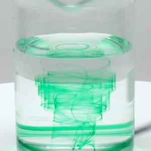 Place a drop of food coloring between the edge and center of the beaker. Spin the air table.