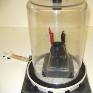 When put into the bell jar all of the buzzers will experience a great loss of volume.  Pads of sorbothane rubber are used to eliminate any vibrations.  Hook the bell to 6 volt battery. With the bell ringing evacuated the bell jar with the vacuum pump. As the air is drawn from the jar the sound will diminish. With the vacuum pump running it is hard to hear the bell.