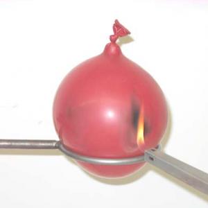 Use the grill lighter to bring a flame to the side or bottom of the water balloon.  Note the there will be some scorching but that the balloon will not burst because the water conducts the heat away from the spot you are touching with the flame.  Compare this to a regular balloon filled with air.