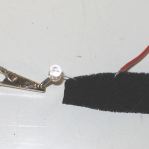 Connect the ( + ) lead of the battery to the proper leg of the LED and then place the other LED leg into the end of the foam.  By placing the other battery lead into the foam at various distances you can make the LED light brightly or dimly.