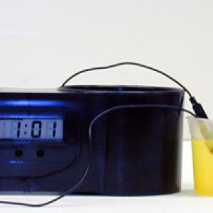 This unit is designed to show that a battery may be made from a acidic fluid or fluid matrix and two electrodes of different materials, in this case copper and zinc. These clocks runs on approximately 2 to 3 volts so the unit has two cells connected in series. Usually I use two small beakers filled with Mountain Dew. Insert a copper and zinc electrode into each beaker making sure that electrodes do not touch each other. The clock should start immediately and can then be set to the correct time. 