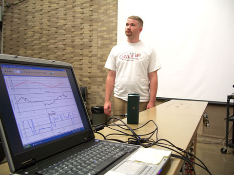 laptop screen with student in the background