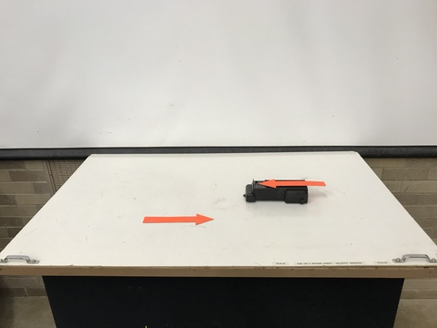 toy car on a sheet with two arrows