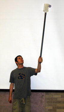 man holding Plexiglas Cup on Pole Apparatus