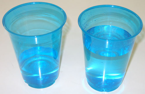 2 plastic cups filled with water 