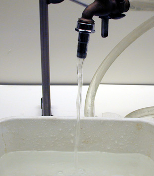 Old fashioned faucet with a plastic wash tub 