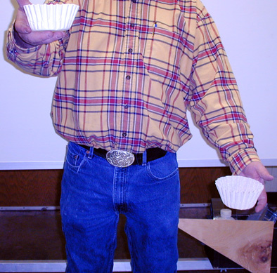 person dropping coffee filters 